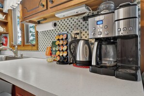 A kitchenette with a coffee maker, a kettle, and a coffee grinder. - Gorgeous New England 4bd Family Lake House w/ Large Yard, Patio, Docks and Views (Strafford)