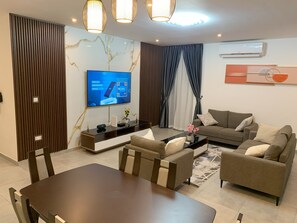 Family Apartment | Living area | 65-inch Smart TV with satellite channels - Nova luxe 2 Bed Executive Stay (Accra)