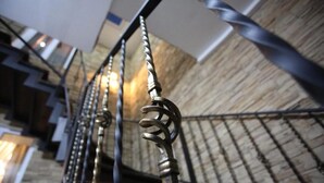Una escalera de caracol con barandillas de metal y piso de madera.