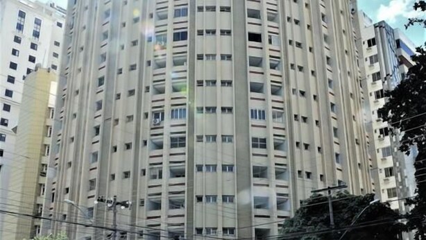 A tall, cylindrical building with multiple floors and balconies.