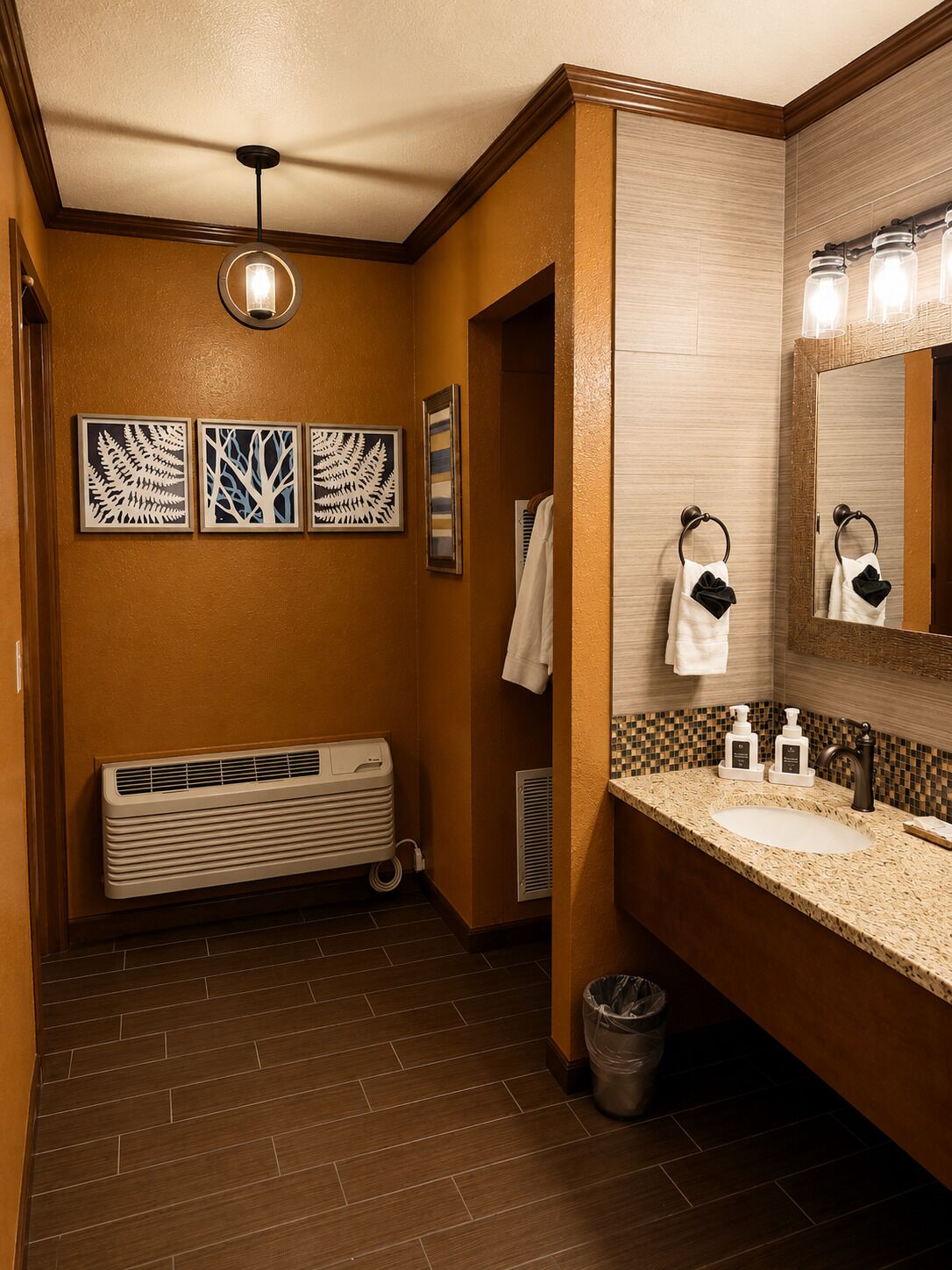 A bathroom with a sink, mirror, towel rack, and decorative wall art.