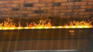 A fireplace with a brick wall background. - James Joyce Coffetel Hotel (Beijing Xizhimen Xinjiekou Subway) (Beijing)