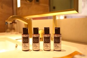 Four bottles of perfume on a bathroom counter. - James Joyce Coffetel Hotel (Beijing Xizhimen Xinjiekou Subway) (Beijing)