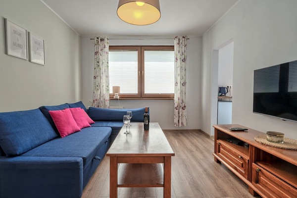 Living Area with Sofa Bed, Dining Table and Smart TV | Book Now with RENTUJEMY.COM