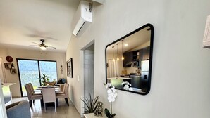 A modern kitchen with a large mirror, a wooden console table, and potted plants. - Beautiful 3-bedroom house in the most exclusive zone of  Sn Miguel with WiFi, AC (San Miguel)
