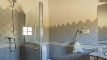 A bathroom with a shower, toilet, and sink.