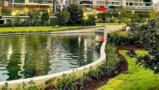 A modern hotel complex with multiple high-rise buildings, a landscaped garden, and a reflective water feature. - Loft Living – Stylish & Central Santurce (San Juan)