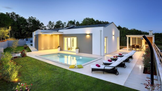 A modern house with a swimming pool, outdoor seating, and a well-maintained garden. - Gorgeous home in Rebici (Rebici)