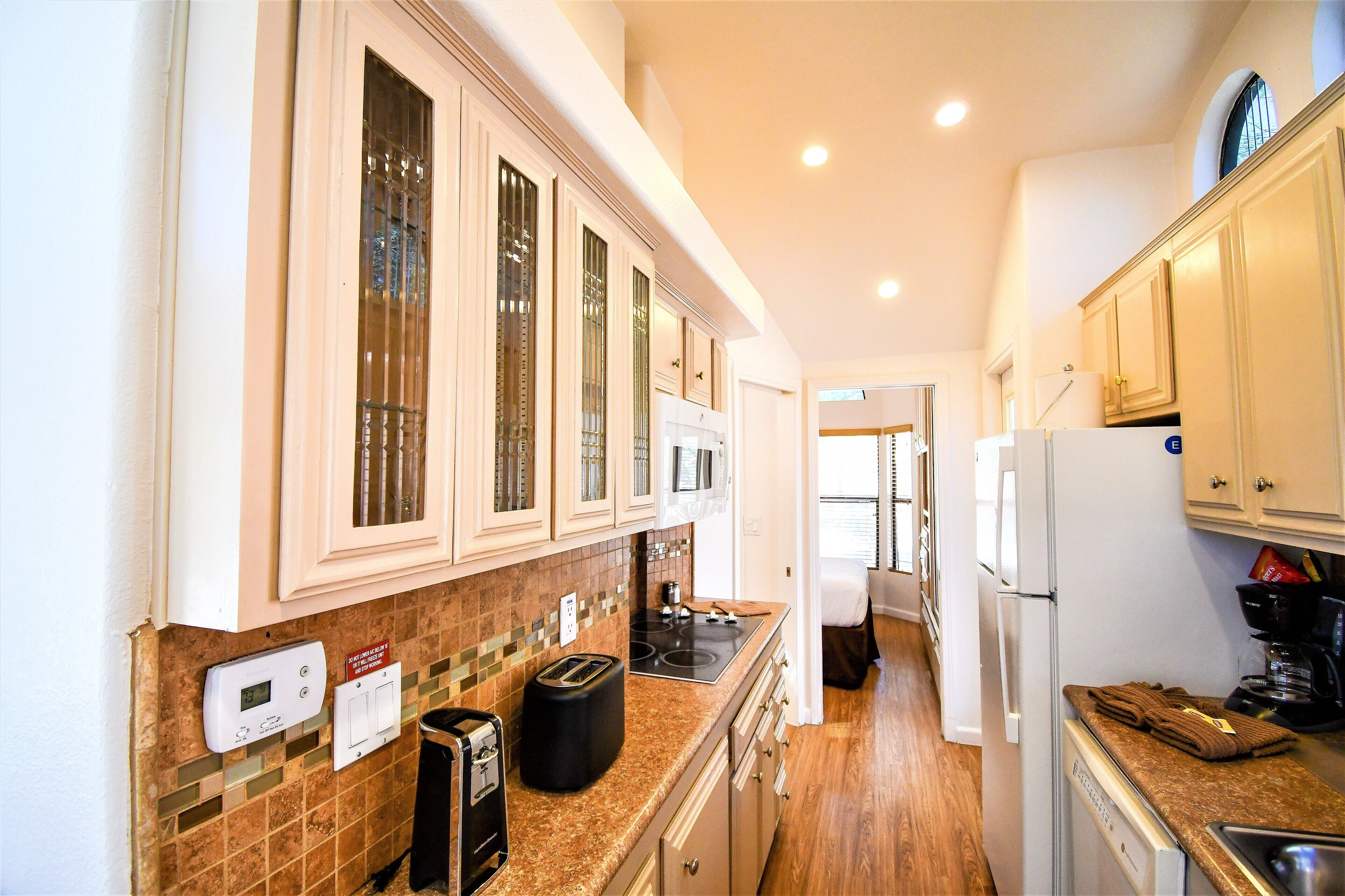 A compact kitchen with a microwave, toaster, and coffee maker.