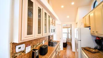 A compact kitchen with a microwave, toaster, and coffee maker.