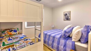 A room with a bunk bed and a single bed, both with colorful bedding. - 142 Page Drive - Alls Well (Blanchetown)