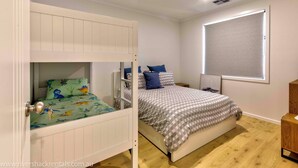 A bedroom with a bunk bed, a single bed, a window with blinds, and a wooden floor. - 142 Page Drive - Alls Well (Blanchetown)