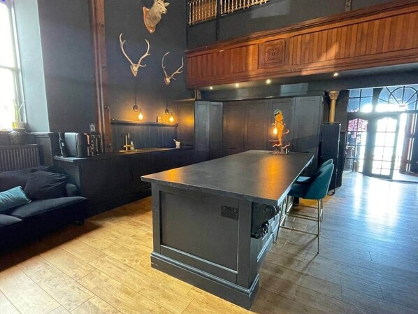 Une cuisine moderne dotée d’un îlot central, de meubles en bois et de décorations murales en forme de bois de cerf.