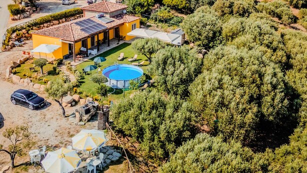 A residential property with a swimming pool, solar panels, and a well-maintained garden.