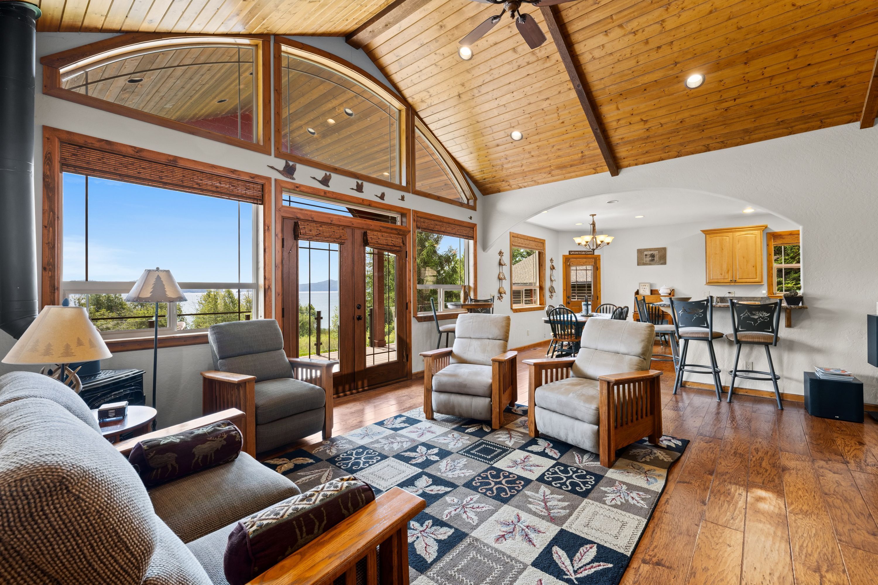 A spacious living area with a large window, a fireplace, and a cozy seating arrangement.