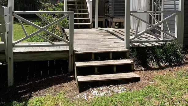 A wooden deck with a covered entrance leading to a house. - Argyles Too! A brand new Loft Efficiency (Kitty Hawk)