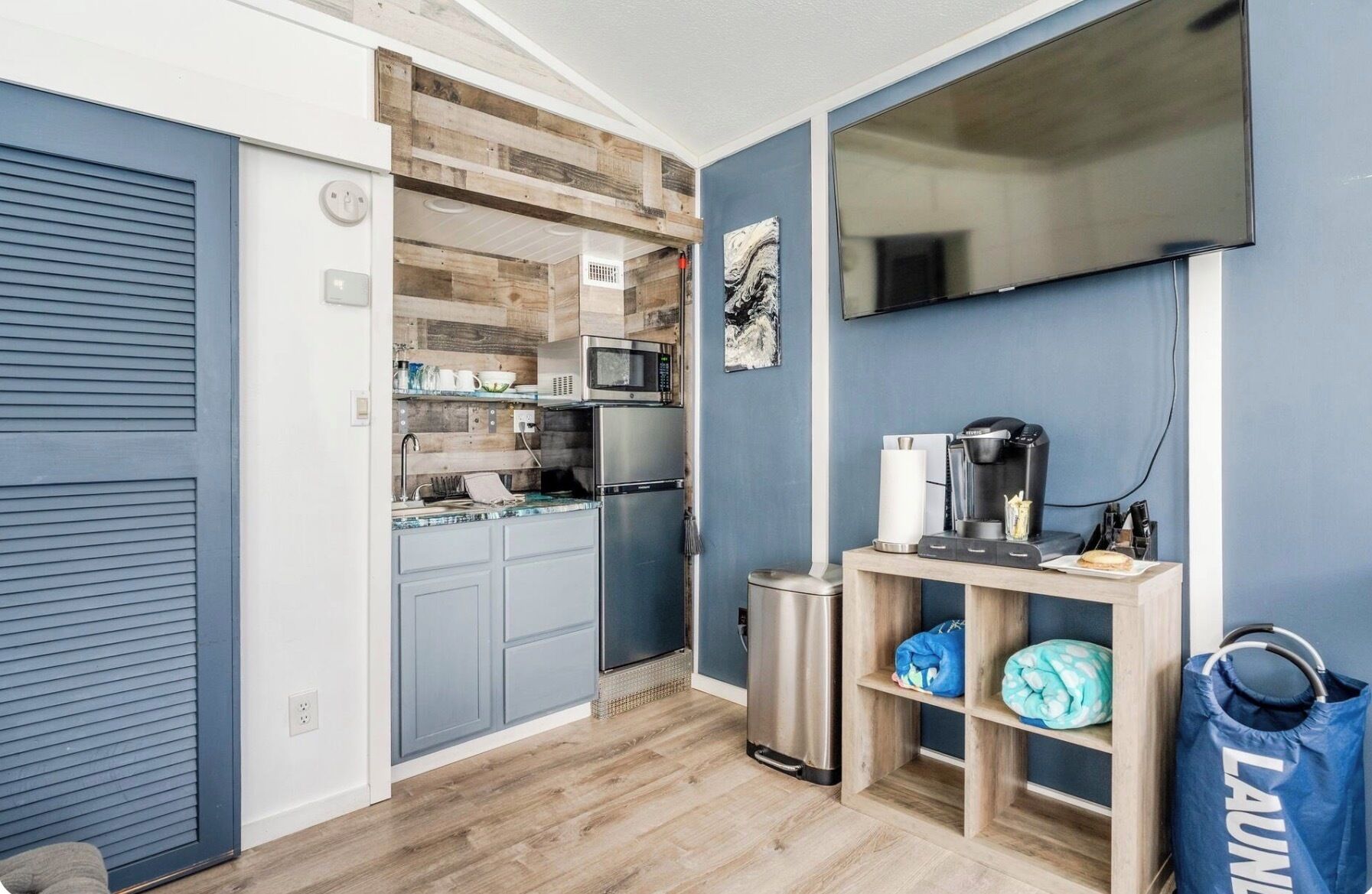 A compact kitchen with a microwave, refrigerator, and coffee maker.