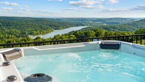 A hot tub with a view of a river and forest. - Lux Lakeview • Pool, Hot Tub, Game Room, EpicViews (Omaha)