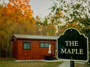 A wooden cabin with a sign that reads 'THE MAPLE.' - The Maple -  New! - Menominee River  Tiny Cottage (Porterfield)