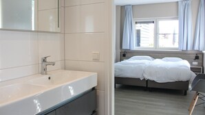 A modern bathroom with a large white sink and a mirror. - Lovely Home In Idskenhuizen - With Sauna (Idskenhuizen)