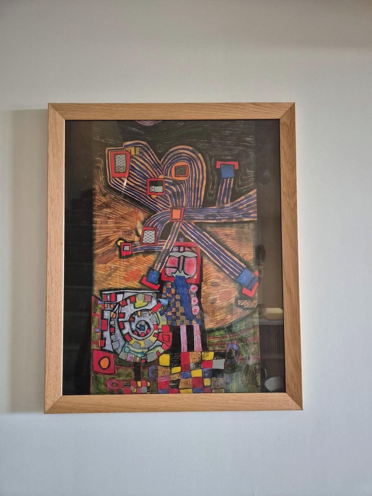 A framed abstract painting with geometric shapes and lines.