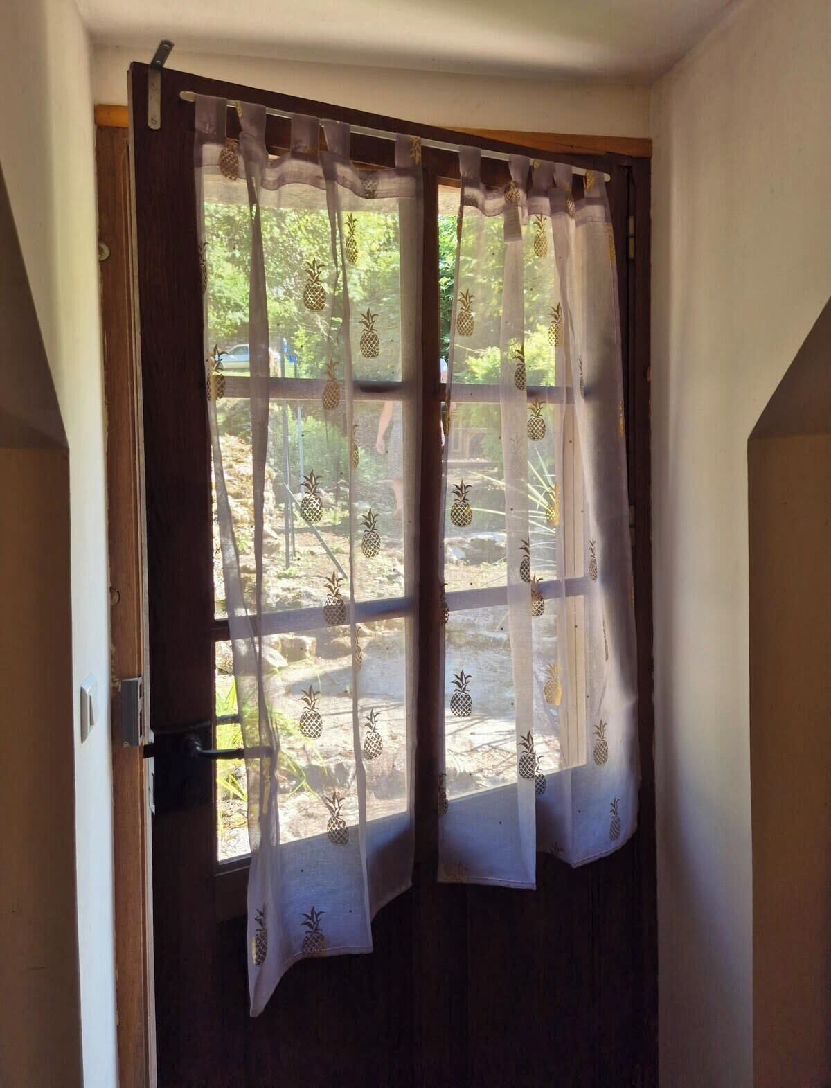 A wooden door with a frosted glass window, featuring a pineapple pattern.