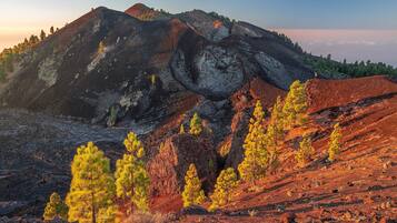 A mountainous landscape with rocky terrain and sparse vegetation.