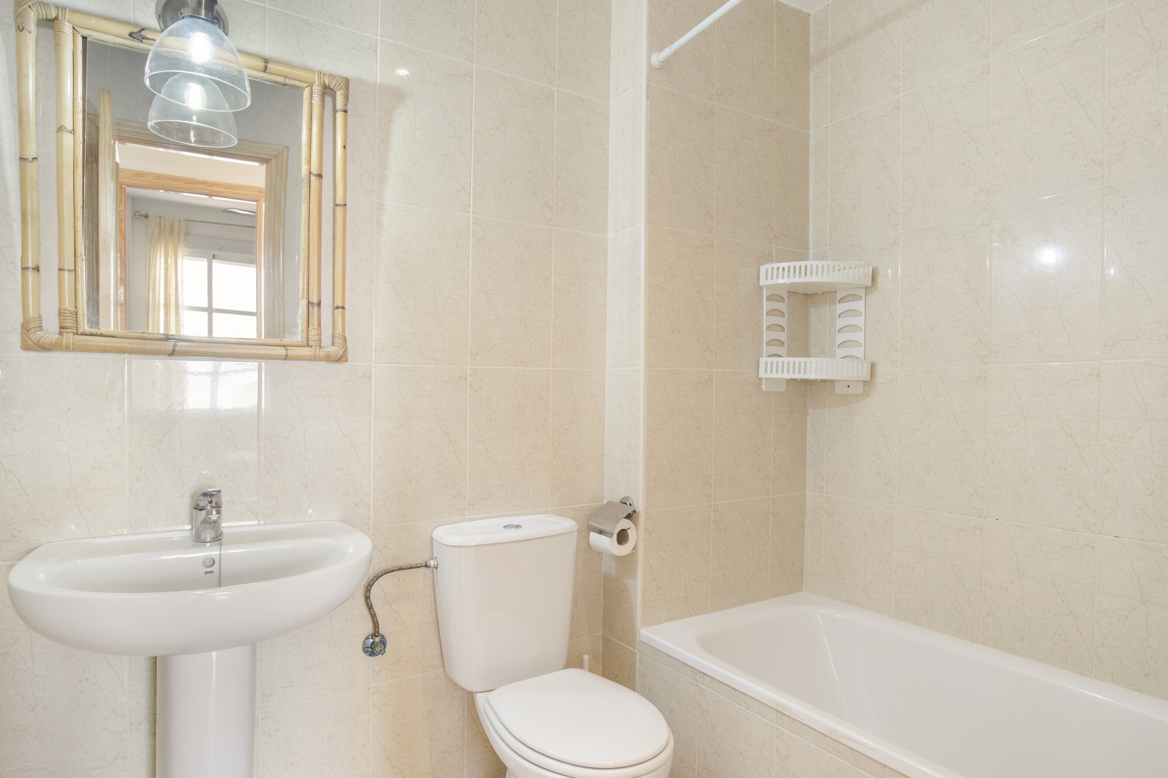 A bathroom with a sink, toilet, and bathtub.