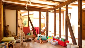 A wooden-framed room with a loft bed, a small table, and a chair. - Guest Room “Chambre Ancolie” – Private Terrace, Shared Garden, Wi-Fi, E-Bike Friendly (L'Épine)