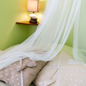 A bed with a white canopy and heart-patterned pillows. - Room "Tilleul" with Private Terrace, Shared Garden, Wi-Fi, and E-Bike Charging (Unknown)