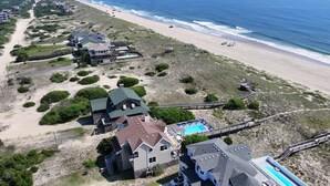 A coastal property with multiple buildings, a beach, and a swimming pool. - OCEANFRONT, wild horses, private pool, hot tub-4x2275, Over at Carova (Carova Beach)