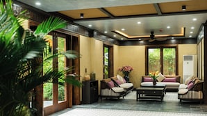 Un amplio salón con un conjunto de sofás, una mesa de centro y un jarrón decorativo.