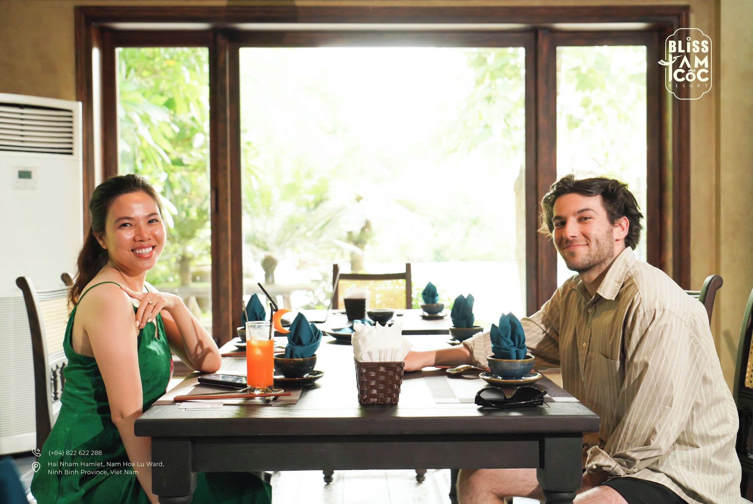 A dining table with chairs, a basket, and a glass of orange juice.