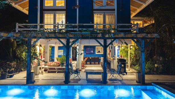A two-story house with a pool, outdoor seating, and a covered patio area. - Casa Azul · Family Retreat & Caribbean Charm (Manzanillo)
