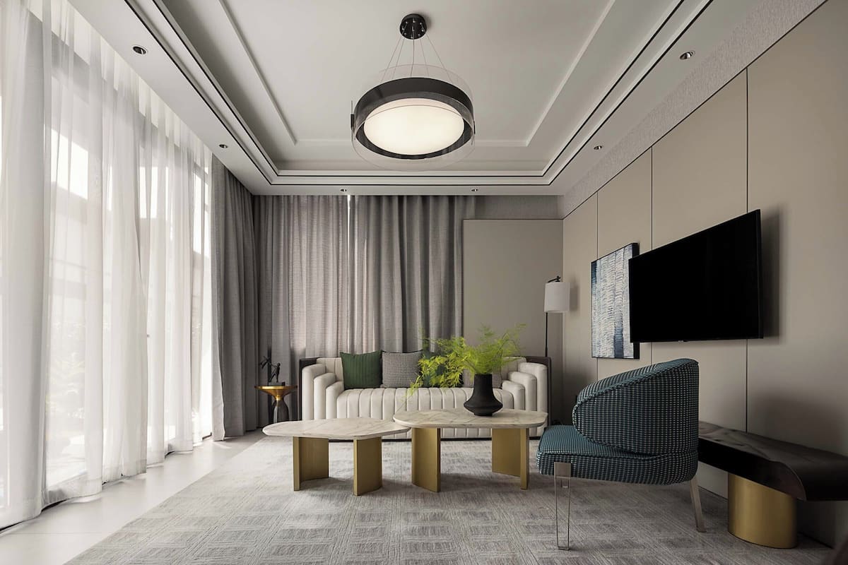A modern living room with a sofa, two coffee tables, a TV, and a large window with curtains.