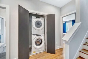 A laundry room with two stacked front-loading washing machines.