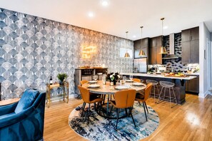 A modern kitchen with dark cabinets, stainless steel appliances, and a central island.