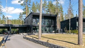 A modern building with a paved driveway and a covered parking area.