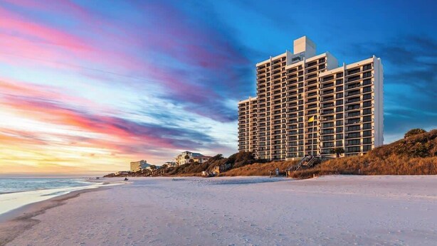 A high-rise hotel with multiple floors, located adjacent to a beach. - One Seagrove Place 1404 (Santa Rosa Beach)