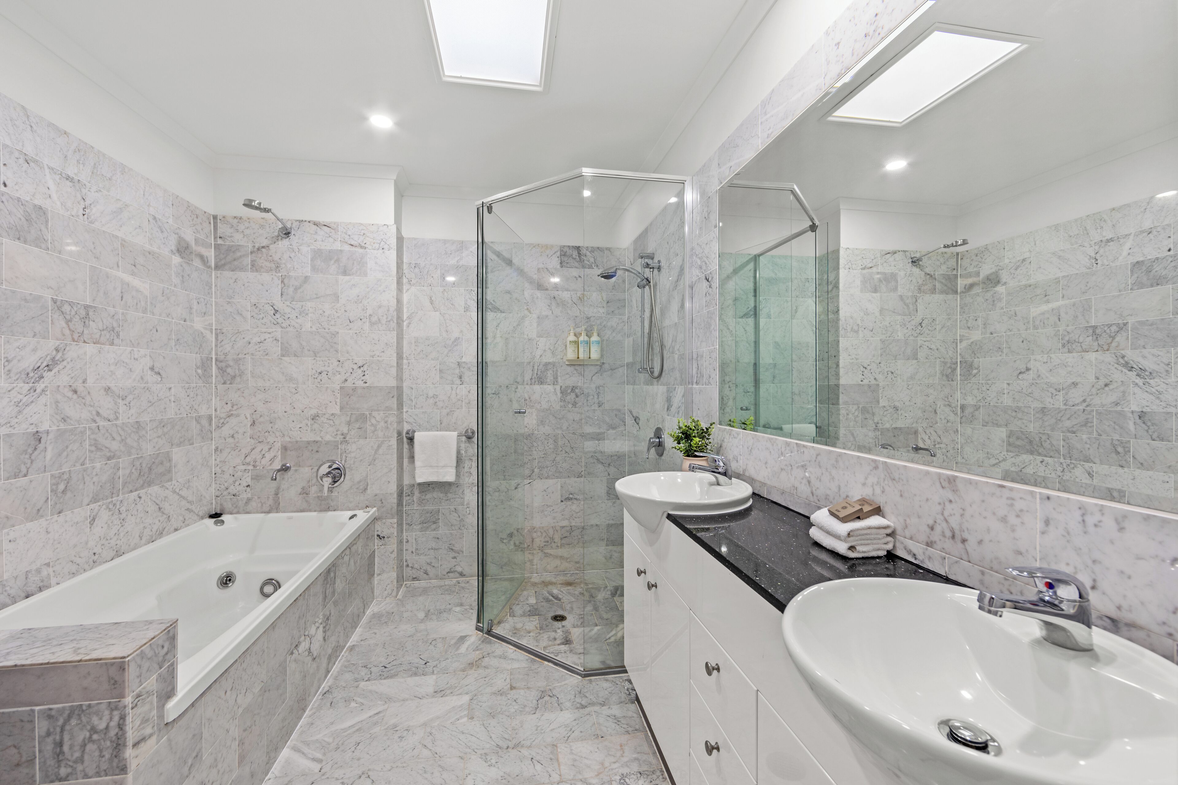 Three Bedroom Three Bathroom Split Level City View Penthouse | Bathroom | Shower, towels, soap, shampoo