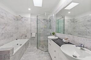 Three Bedroom Three Bathroom Split Level City View Penthouse | Bathroom | Shower, towels, soap, shampoo