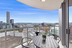A balcony with a view of a cityscape, including a tall building and a construction crane. - CLLIX Brisbane Central Apartments (Brisbane)