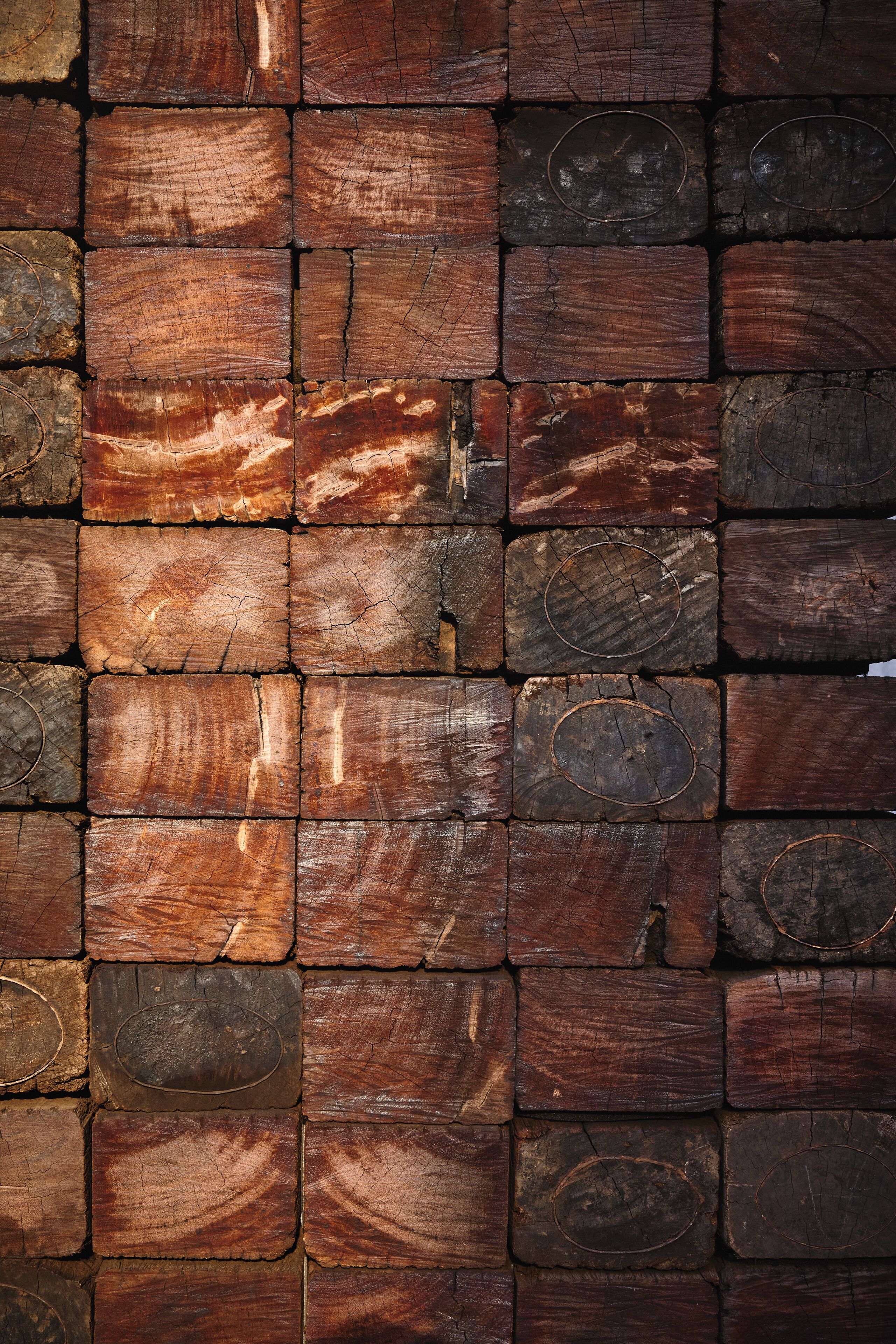 A wall made of variously sized and shaped wooden planks.
