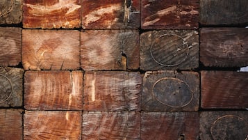 A wall made of variously sized and shaped wooden planks.