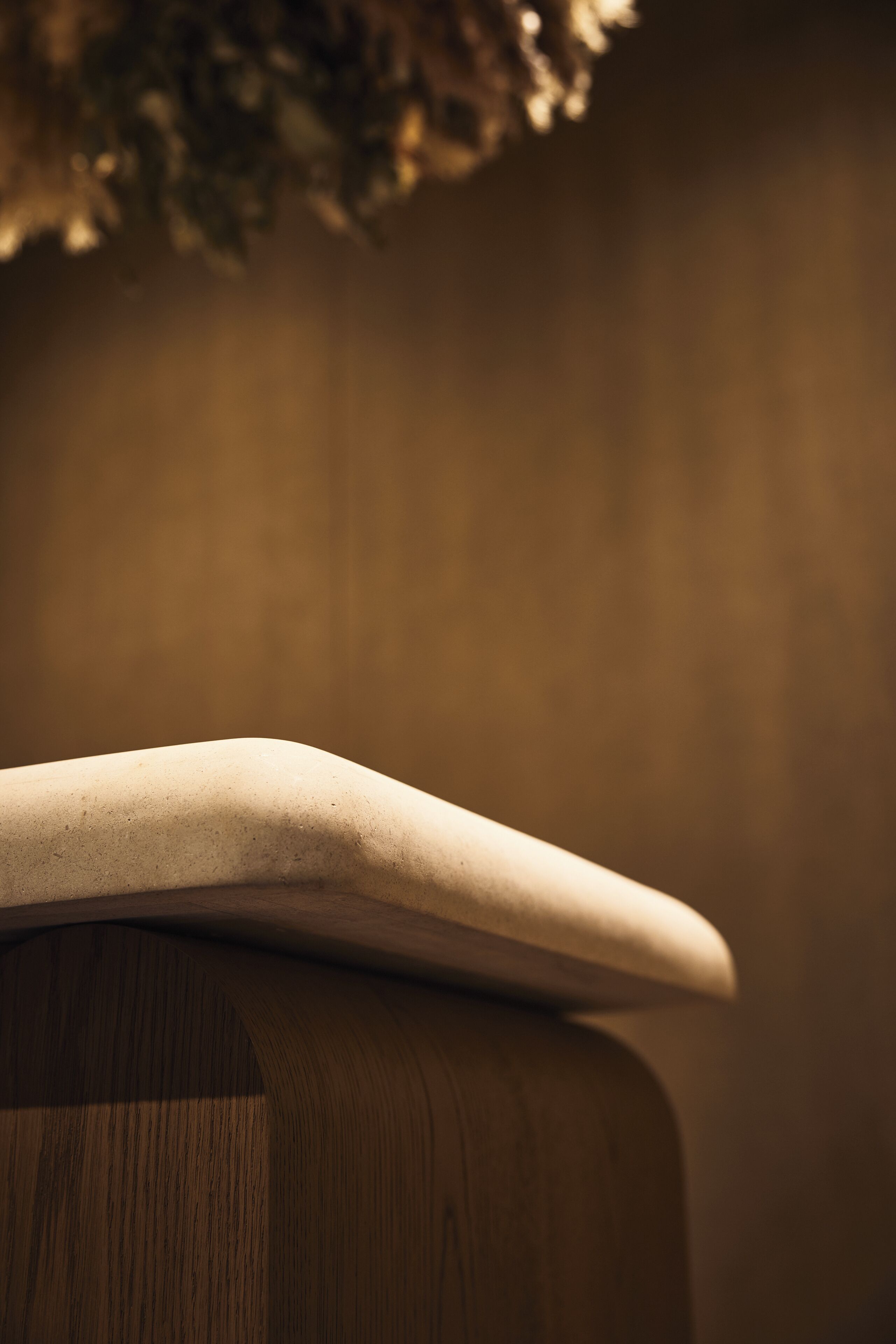 A close-up of a wooden surface with a curved, flat object on top.