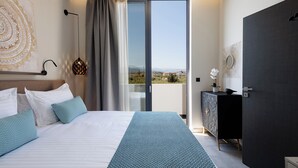 A modern bedroom with a large bed, a view of the outdoors, and a dark-colored wardrobe.