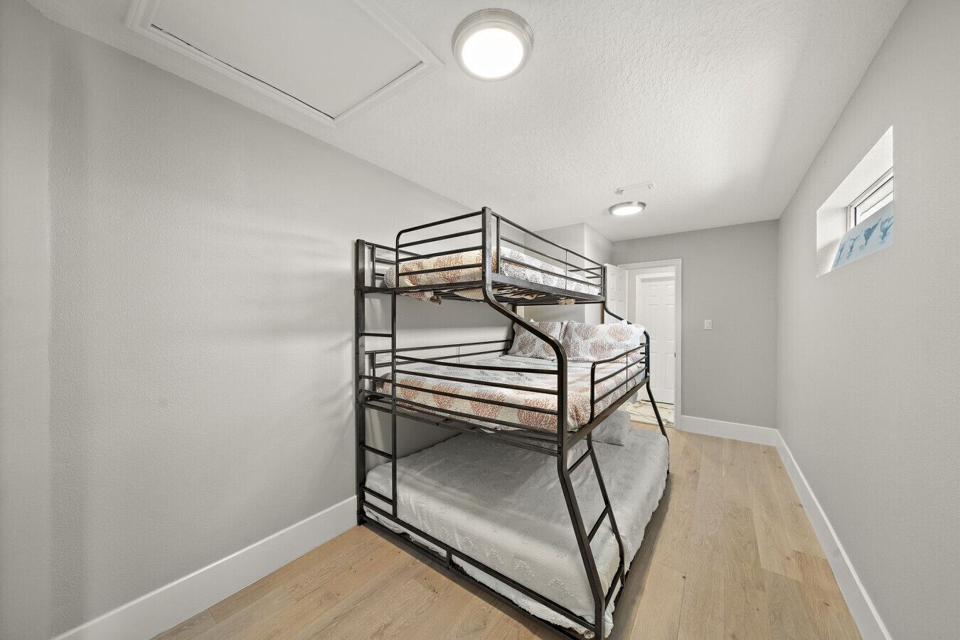 This bedroom has a twin over double over full bunk bed