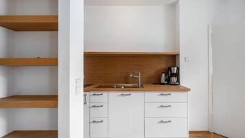 Fridge, coffee/tea maker, high chair, cookware/dishes/utensils