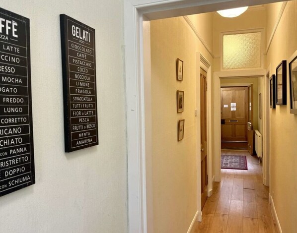 A hallway with two black signs listing Italian coffee and gelato flavors. - Charming 2-bedroom apartment with WiFi in wonderful Edinburgh (Edinburgh)