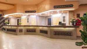 A reception area with a reception desk, information desk, and a mail slot. - Empire Hotel Aqua Park (Hurghada)